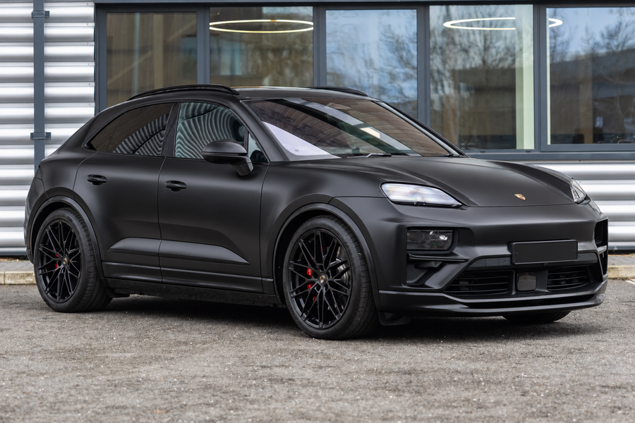 Electric Porsche Macan in satin black on factory alloy wheels, the generation that moved to a 5x130 bolt pattern